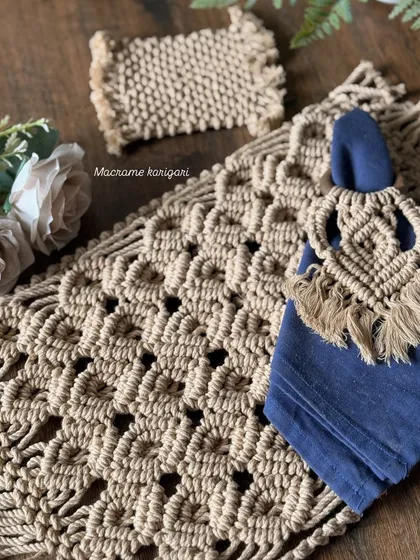 Elevate your dining experience with our macramé table decor set. This collection, featuring a detailed placemat, coaster, and fringed napkin ring, adds a touch of handcrafted elegance to any meal.