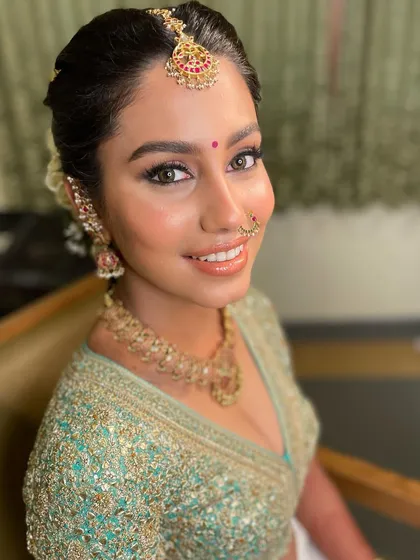 A close-up on that bridal glow. You can see the luminous skin and the soft, shimmery eyeshadow that makes her eyes sparkle.