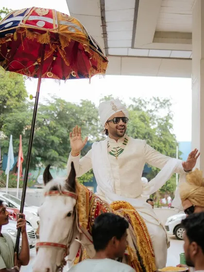 A classic baraat moment with the groom on a white horse. We ensure all traditional aspects of the wedding are beautifully planned and executed.