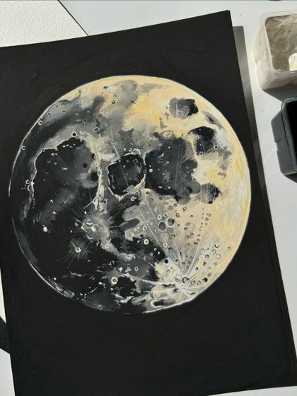 A close-up detail shot of the moon painting. You can really see the layers and textures I built up with the gouache paint to create the craters and shadows.