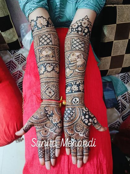 This bridal design uses a mix of bold floral patterns and delicate checkered fills. The contrast between the dark and light areas makes the motifs pop, creating a striking look.