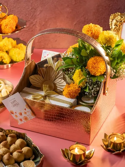An elegant Diwali hamper featuring a floral arrangement, our dessert boxes, and traditional diyas. I love creating custom bulk gifting solutions for the festive season.