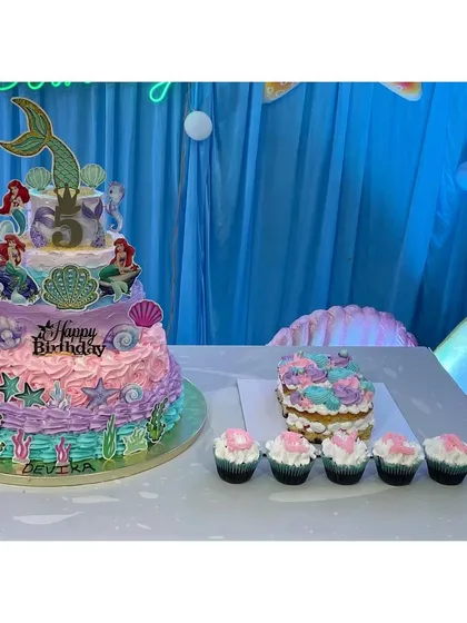 This five-tier mermaid theme cake was a special project for a 5th birthday party. I create large, multi-layered celebration cakes with detailed themes, all made with whipped cream and no fondant.
