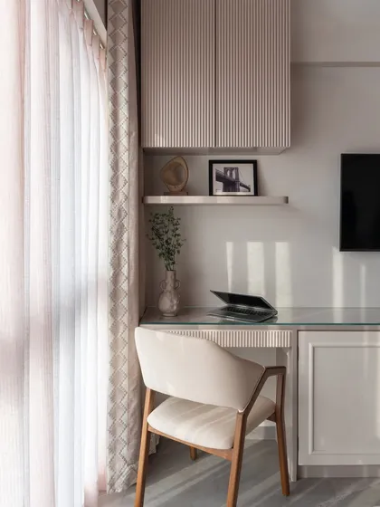 A perfect example of a multi-functional bedroom. This calm corner features a study desk seamlessly blended into the TV unit, creating a peaceful and productive workspace without disrupting the room's restful energy.