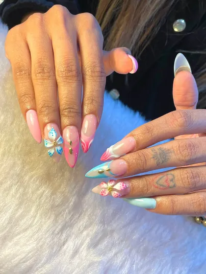 This look is all about being the main character. We created this set with long acrylic extensions, a soft pastel pink and blue base, and delicate 3D floral and butterfly accents for a touch of whimsy.