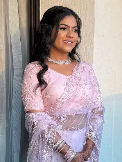 The bride in her beautiful pastel saree, her makeup glowing in the soft light. This is the essence of modern elegance.