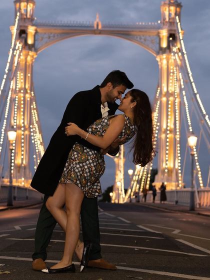 A playful and dynamic pose on the Albert Bridge. The groom dips the bride, creating a fun, romantic-comedy movie moment against the iconic London landmark.
