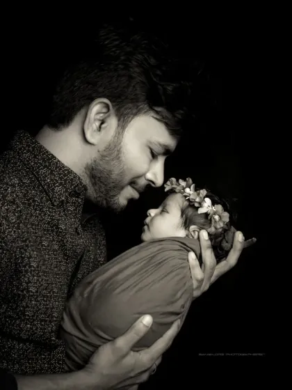 A father's love, etched in light and shadow. This dramatic black and white portrait captures the deep, emotional bond between a dad and his newborn.