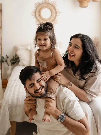 Another angle from a playful family session. The joy is contagious as this little girl sits on her dad's shoulders.