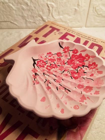A different angle of our hand-painted cherry blossom mini shell dish, a piece that combines our love for coastal shapes and floral art.