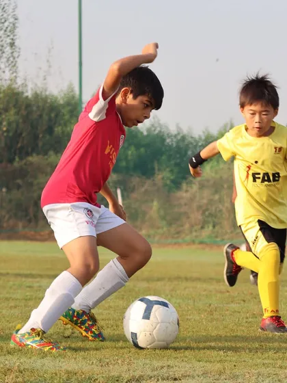 A player in action during a match. Every training session and match offers invaluable experiences, fostering skill development and resilience.
