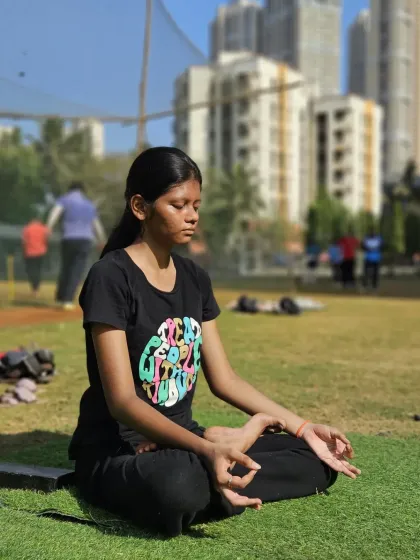 A young athlete finds her zen during an outdoor morning session. We believe in training the mind alongside the body for complete well-being.