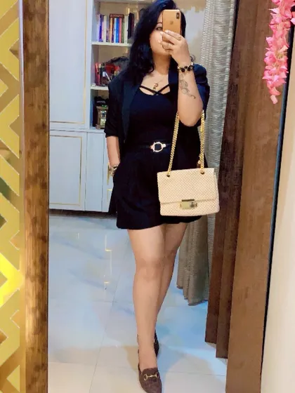 An all-black ensemble is the epitome of chic power. This look, featuring a belted romper and blazer, is perfect for an evening business event or a sophisticated night out.