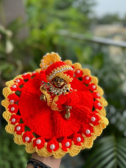 A vibrant red and yellow Kanha Ji dress, complete with a matching turban. This is a classic and auspicious color combination.