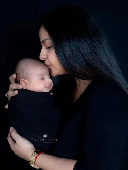 A tender moment between mother and child, with a soft kiss on the forehead. These are the quiet, loving moments I aim to capture.