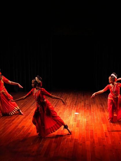 Dancers from my Kimaham school in a dynamic formation. The interplay of light and shadow on the stage enhances the dramatic effect of the performance.