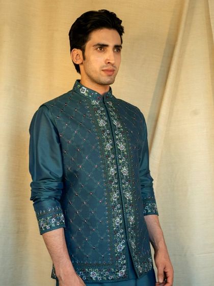 For the modern gentleman, our Reshmi Embroidered Teal Jacket is a masterpiece, an amalgamation of delicate embroideries and patterns.