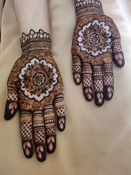 This is a great example of mandala cutwork, where the design is created by leaving negative space. The bold central mandala surrounded by detailed finger work creates a striking and modern look.