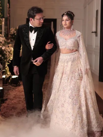 The couple makes a grand entrance. The bride's makeup is designed to be magical and long-lasting, perfect for a glamorous reception.