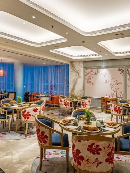 The Oriental Pavilion at Taj Devi Ratn, where I used cherry blossom motifs on upholstery and walls to evoke the elegance of East Asia. The combination of rich reds and blues creates a warm, inviting atmosphere for diners.