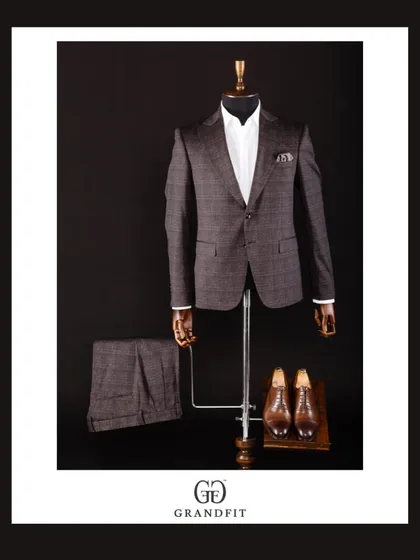 This two-piece suit in a brown plaid fabric is a perfect example of smart, transitional formalwear, suitable for a range of events.