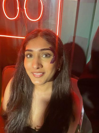 A small, delicate purple glitter design on the cheek. This is a great example of a minimal yet beautiful glitter accent.