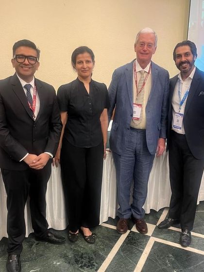 Posing with my respected colleagues at a professional event. Continuous education and collaboration are key pillars of our practice at Ojas Skin Care.