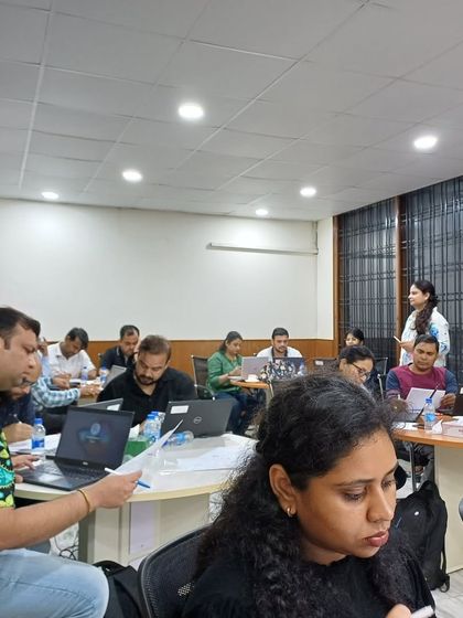 An Engaged Classroom: The Goal of Every Corporate Training. A wide shot of our Advanced Excel workshop, showing a room full of focused professionals. My goal is to create a learning environment that is both intensive and highly engaging.