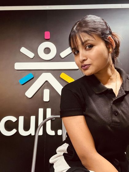 Posing with the Cult.fit logo. I am proud to be a trainer with a brand that is revolutionizing fitness in India.