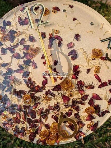 A full view of the 12-inch floral wall clock. The combination of red and yellow flowers with gold accents makes for a very warm and inviting piece.