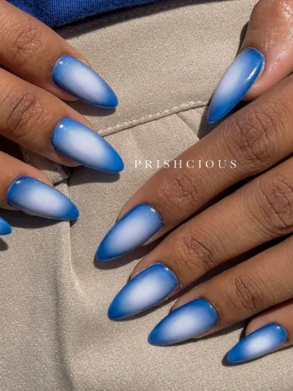 A classic blue and white aura design on long, almond-shaped nails. The gradient is so smooth, creating a beautiful sky-like effect.