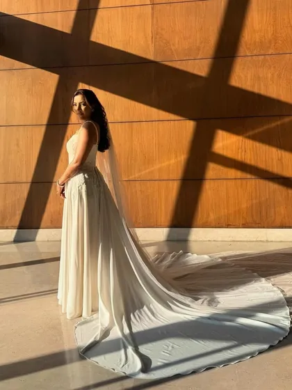 A stunning full-length shot with her long train. The soft glam makeup adds to the drama and elegance of this beautiful bridal portrait.