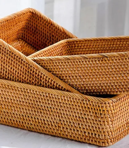 A set of nesting rectangular trays or baskets made from finely woven rattan. These are perfect for organizing drawers, serving bread, or keeping small items tidy on a coffee table or desk.