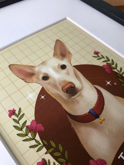 An angled, close-up view of the framed Togo portrait. This perspective highlights the smooth finish of the print and the quality of the frame.