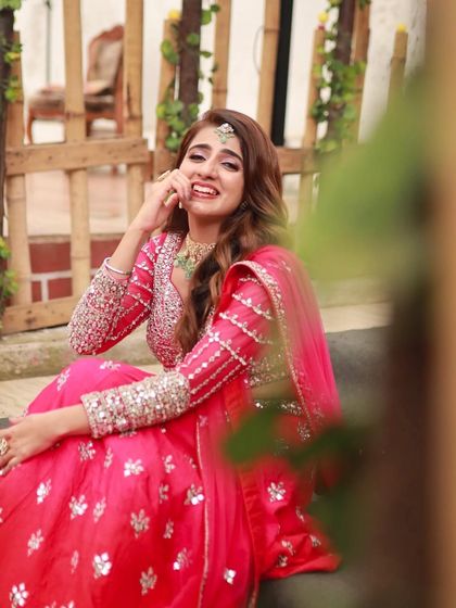 The bride's happy and playful expression is captured perfectly. This look is all about celebrating love and happiness.