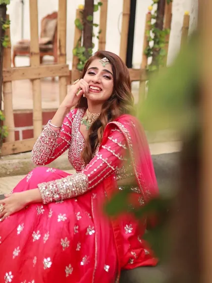 The bride's happy and playful expression is captured perfectly. This look is all about celebrating love and happiness.
