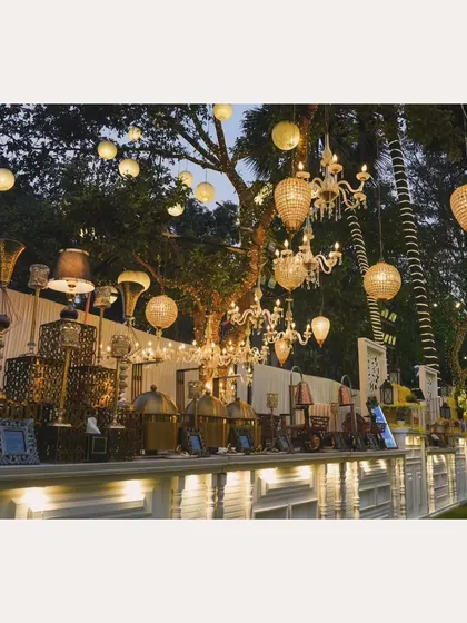 My buffet setups are designed to be a centerpiece of your event. Here, ornate chandeliers hang above a beautifully lit counter with golden chafing dishes, creating a look of pure luxury.