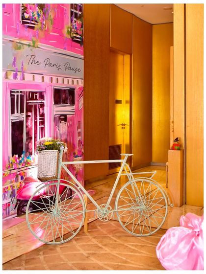A charming Parisian street scene I created, with a hand-painted backdrop of a pink cafe and a vintage-style bicycle with a basket of flowers. It’s these picturesque details that make a theme truly immersive.