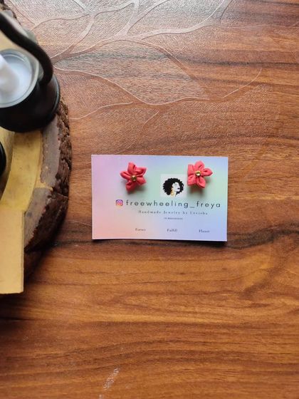 Tiny, hand-painted flower studs in a bright red color. These are perfect for when you want just a small pop of color and handmade detail.