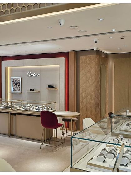 Within the TimeVallée boutique, we implemented distinct brand corners, such as this one for Cartier. The design uses the brand's signature color palette and quilted wall panels to create a dedicated, immersive space that reflects Cartier's unique identity.