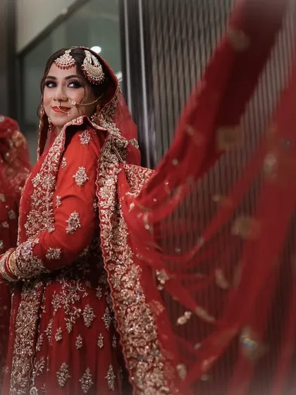 A beautiful shot capturing the bride and her reflection. The flowing red dupatta adds a touch of drama to this classic and elegant Nikah look.