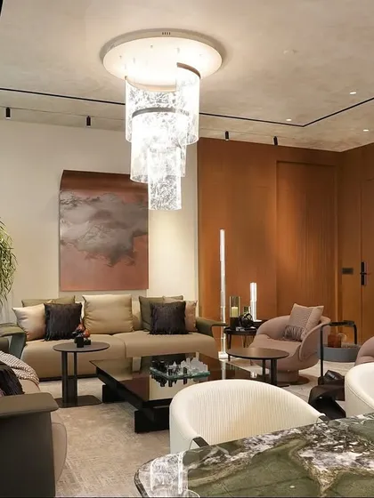From this angle, you can see how the living area's plush seating and the dining space's elegant marble table coexist. The design ensures the home feels functional for daily life and elevated for entertaining guests.