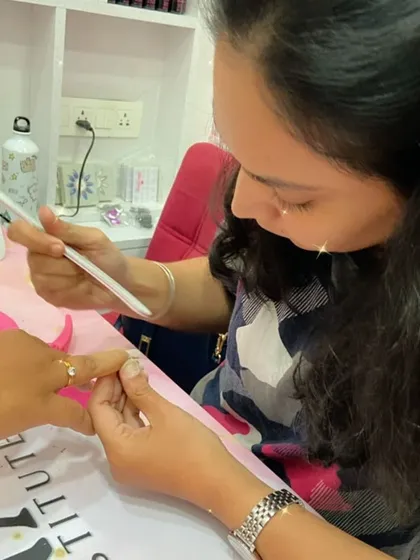 A student practices filing and shaping, a crucial step in preparing the nail for any service.