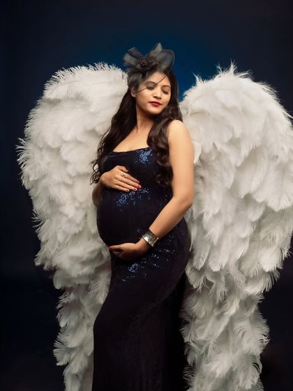 A serene side profile of our angelic mom-to-be, with her hands gently cradling her bump.