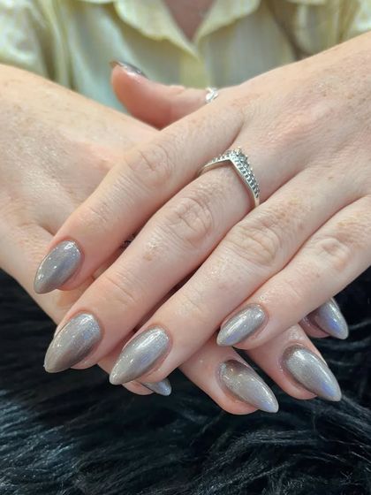 Another view of the elegant gunmetal chrome nails. This pose highlights the smooth, mirror-like finish and the unique color that complements any style.