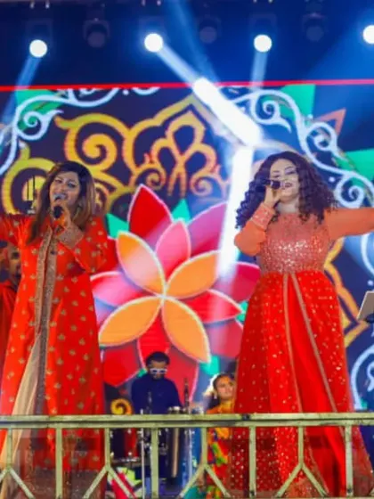 On stage, we feed off the crowd's energy. Here we are, getting everyone hyped up during a Navratri performance, with our amazing band providing the perfect backdrop.