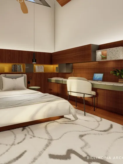 A bedroom with a vaulted ceiling and a custom-built wooden headboard that incorporates a long desk and shelving. The design maximizes space and functionality while maintaining a clean, modern aesthetic with green and wood tones.