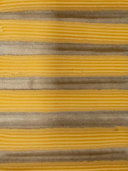 Freshly piped choux pastry, ready to be baked into eclairs.