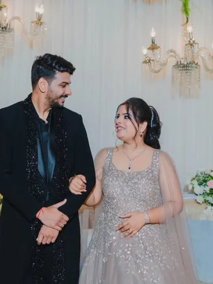 The couple sharing a sweet, knowing glance during their reception, a candid moment that speaks volumes about their connection.