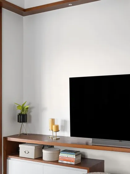 A corner of the 'Gulmohar' family space, featuring a custom floating TV unit with both open and closed storage.